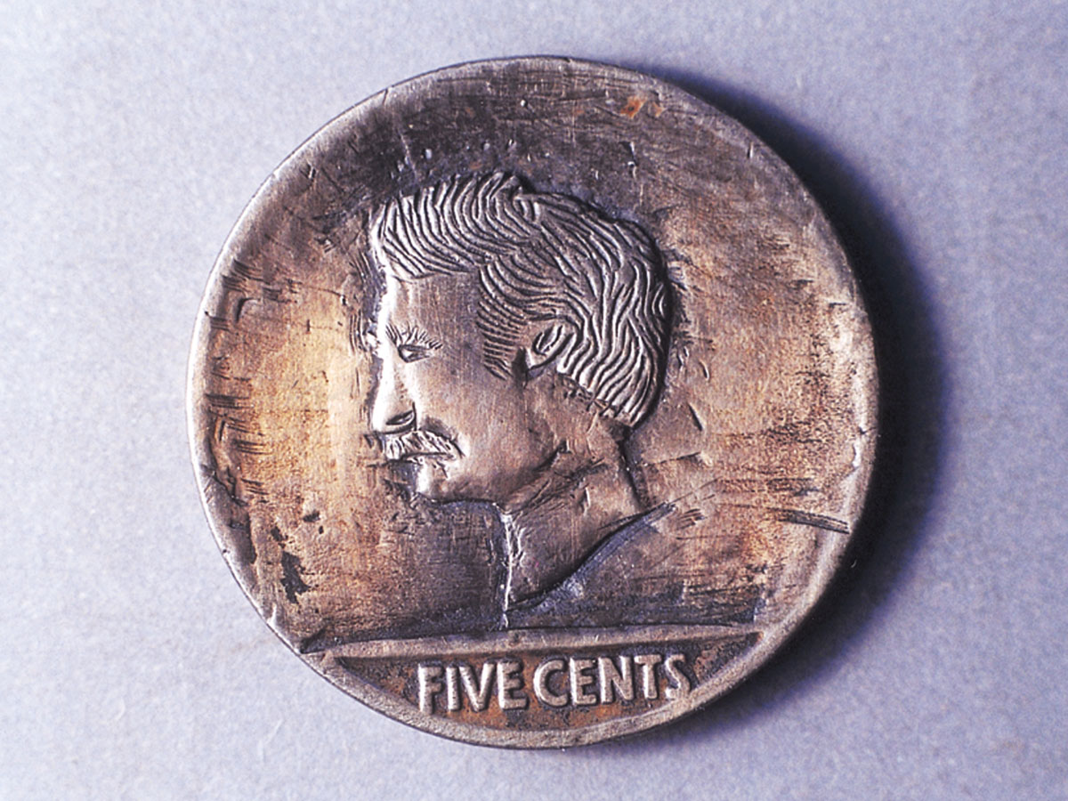 A photograph of a nickel carved into the likeness of Mark Twain.