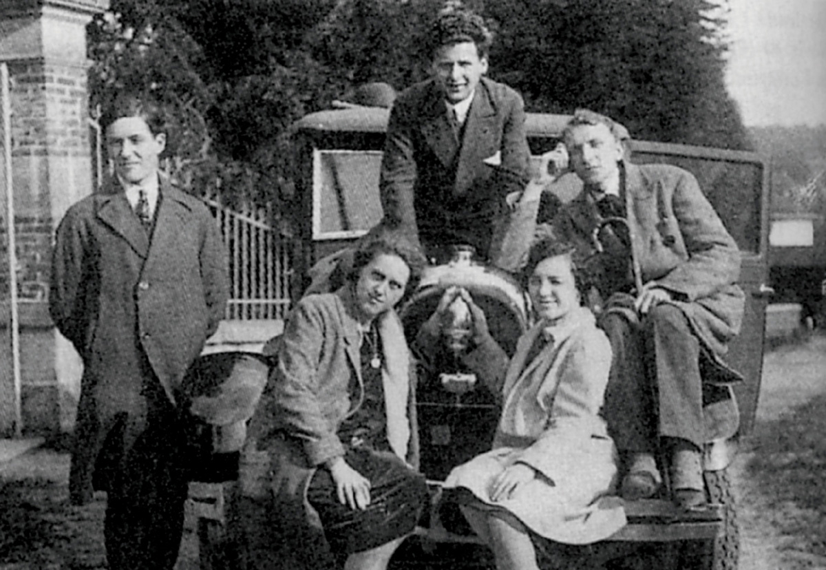 A photograph of Maurice Blanchot, Emmanuel Lévinas, and three other friends, ca. nineteen twenty five, gathered around a car on their way to dine at the home of Charles Blondel, professor of psychology at the University of Strasbourg, where Blanchot and Lévinas were enrolled.