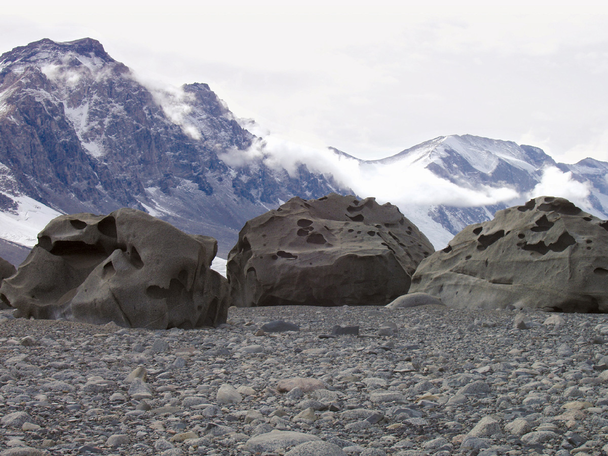 A photograph by artist Jackie Dee Grom of a group of three ventifacts.