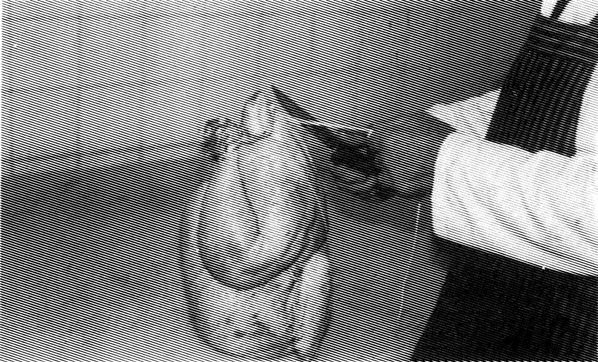 An undated photograph showing a man trussing a chicken. The image was labled “Trussing: Tie off at Parson’s nose.” 