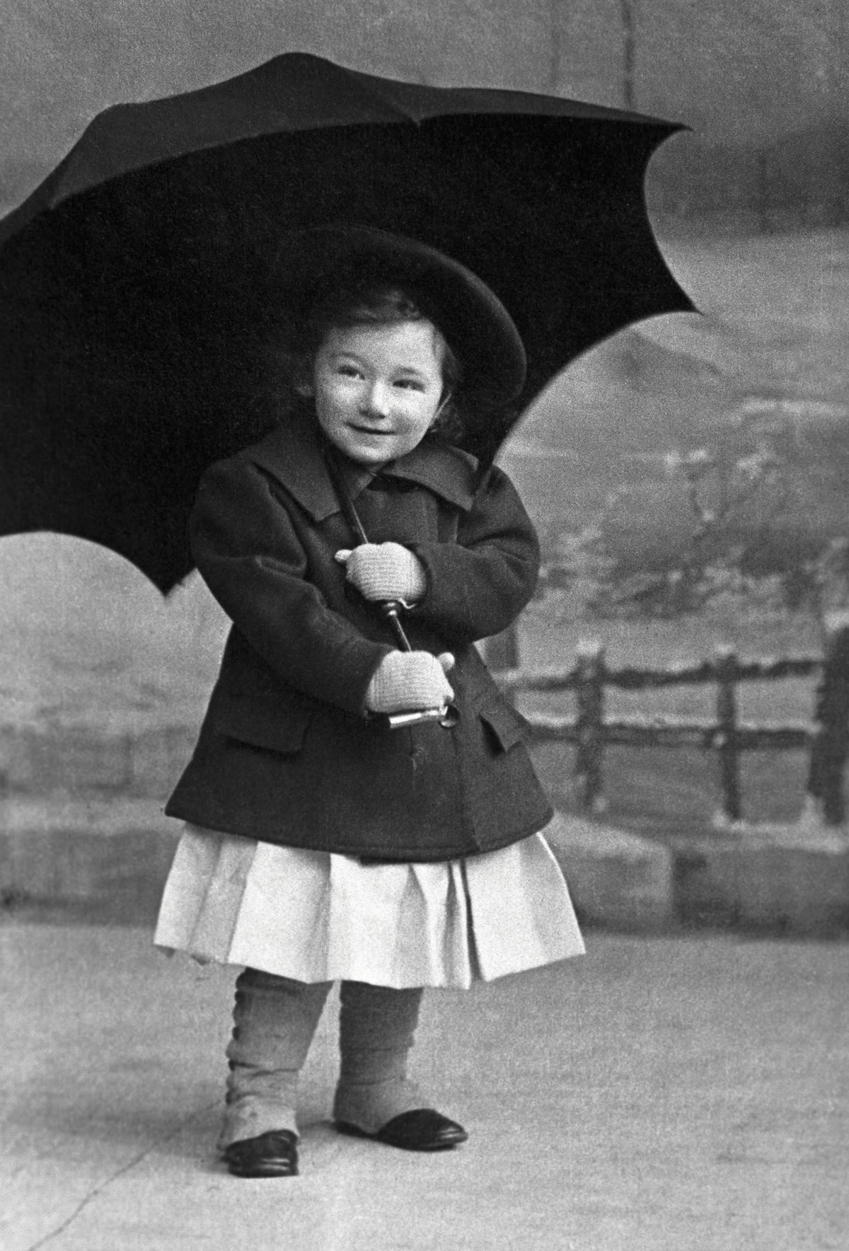 A photograph titled “Portrait of Otto Bettmann—About 2 Years of Age, With an Umbrella.” Available through Corbis for a fee.