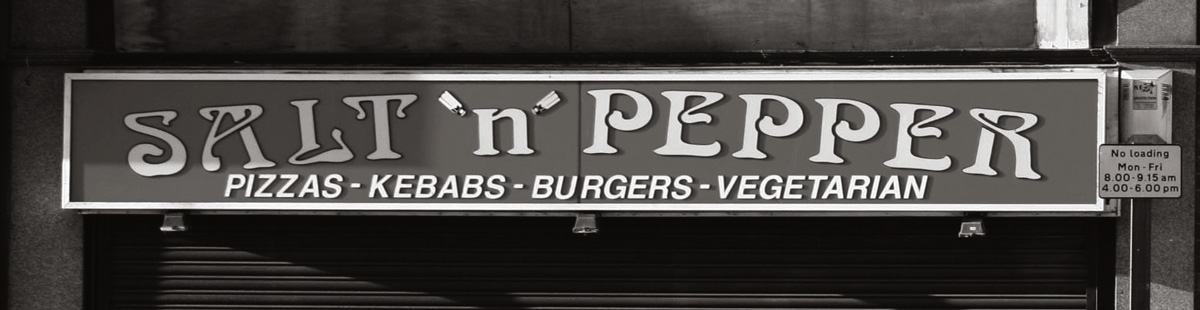 A photograph of a shop sign for a restaurant called “Salt N Pepper.”