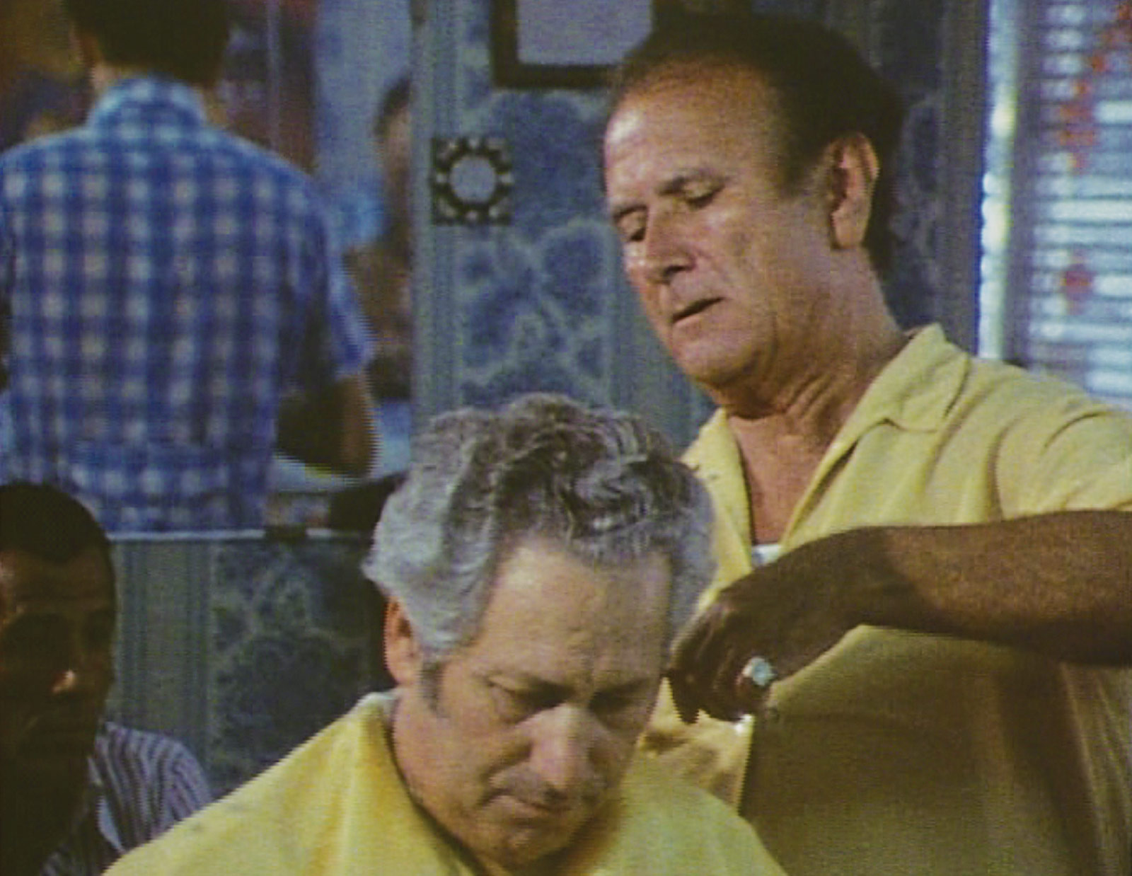 Still from the nineteen eighty five film “Shoah,” by Claude Lanzmann, depicting a scene in a barber shop from various angles.