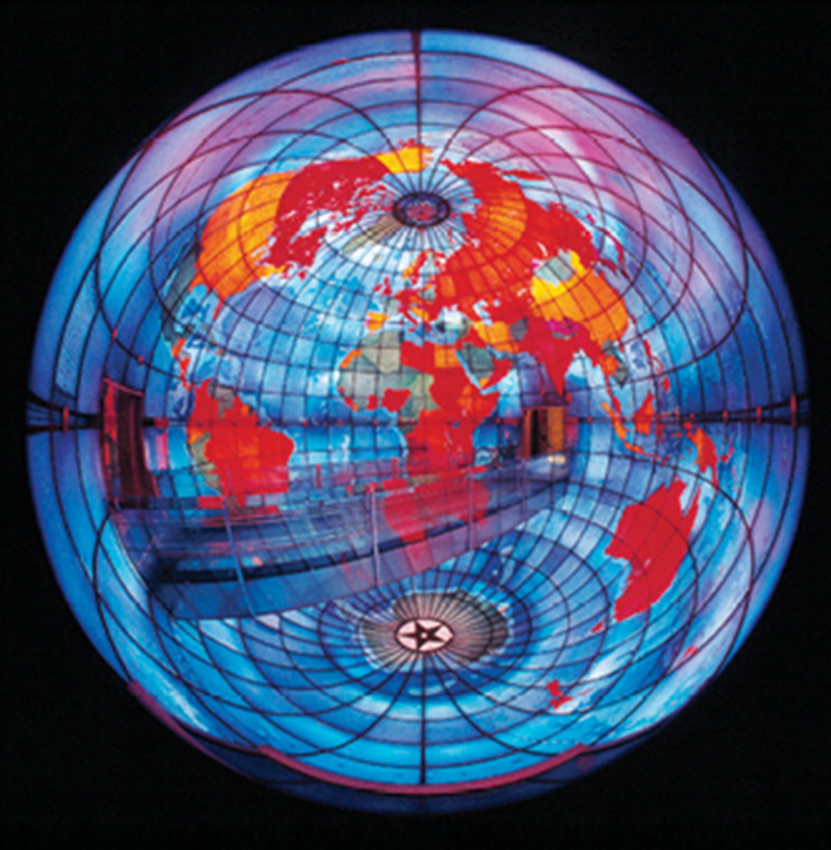 A photograph of the three-story-tall stained glass Mapparium, an inside-out globe traversed by a glass bridge, at the Mary Baker Eddy Library in Boston. 