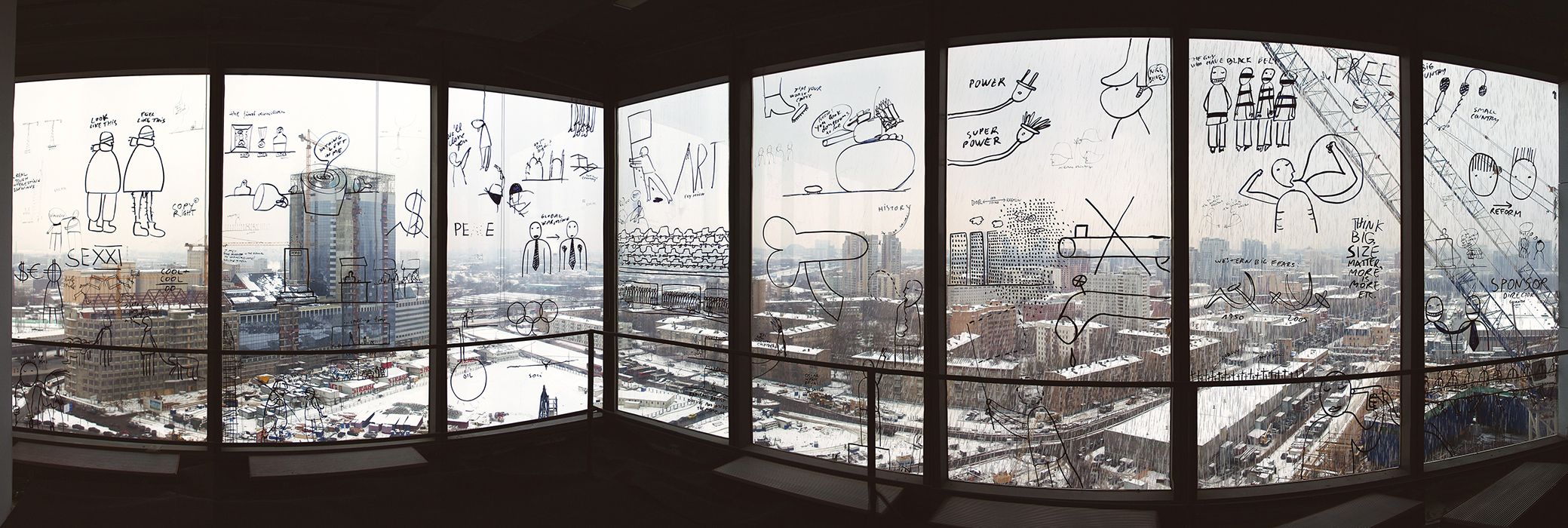 A panoramic photograph of a series of windows in Moscow covered with drawings and text created by artist Dan Perjovschi.