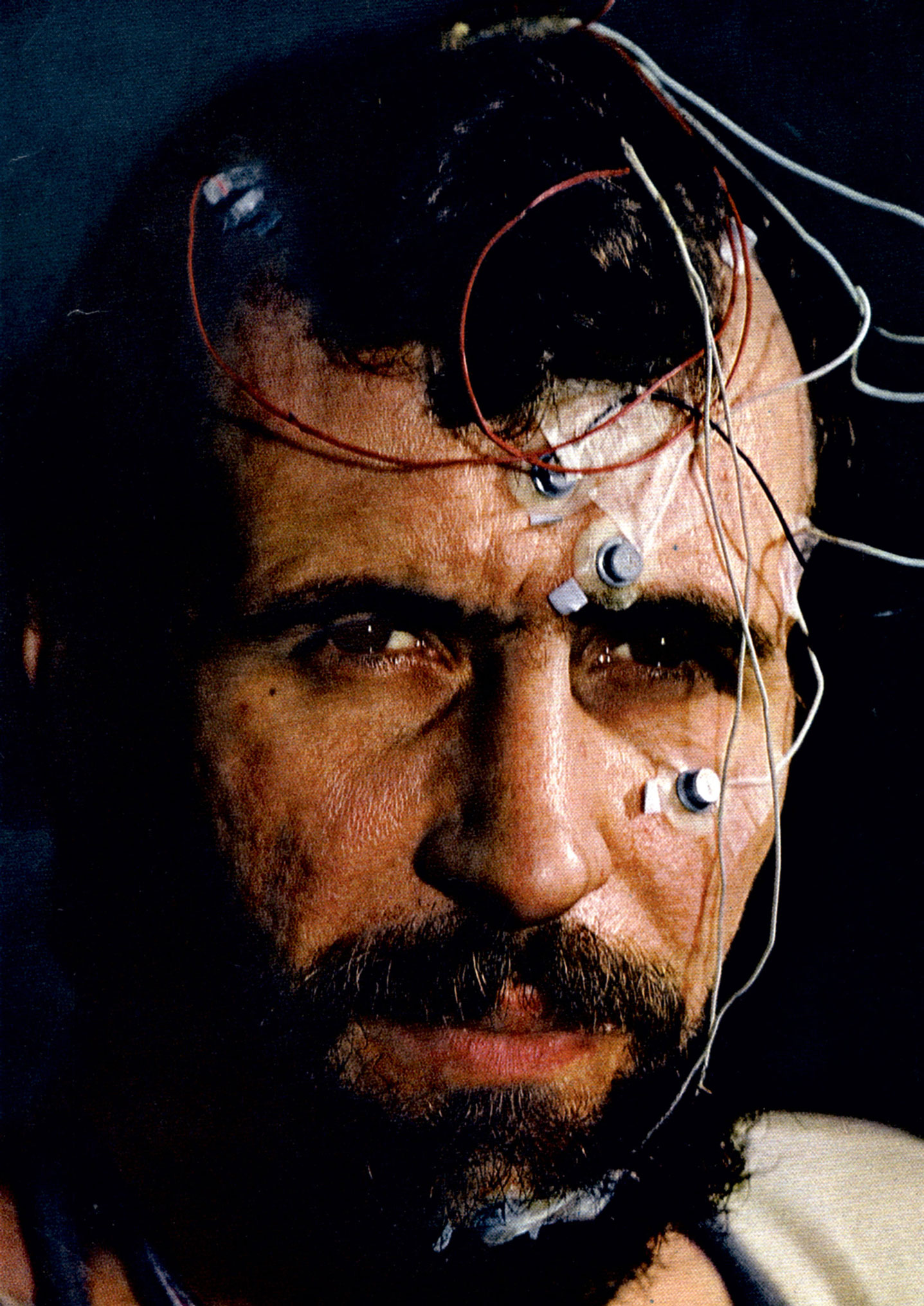 A photograph of Siffre adorned with the electrodes that monitored his heart, brain, and muscle activity during his nineteen seventy-two experiment.