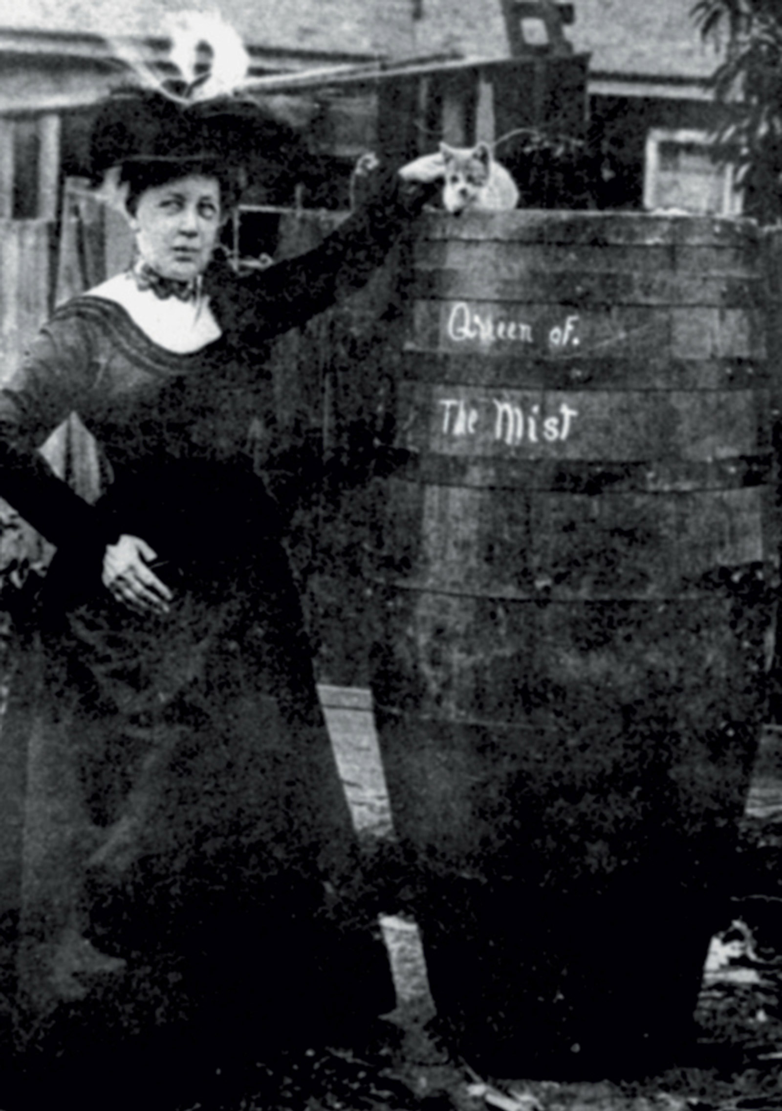 A photograph of Annie Edson Taylor standing next to her barrel.