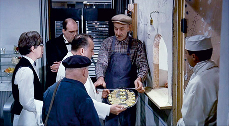 A still from Jacques Tati's 1967 film Playtime which shows plaice being served.