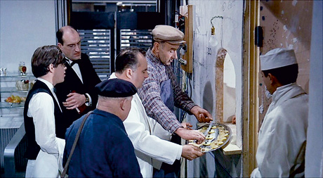 A still from Jacques Tati's 1967 film Playtime which shows plaice being served. 