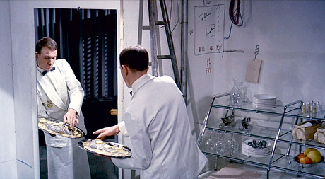A still from Jacques Tati's 1967 film Playtime which shows plaice being served.