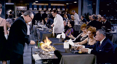 A still from Jacques Tati's 1967 film Playtime which shows plaice being served.