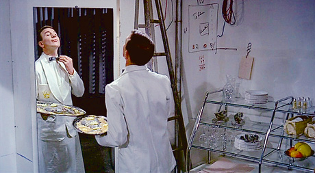 A still from Jacques Tati's 1967 film Playtime which shows plaice being served.