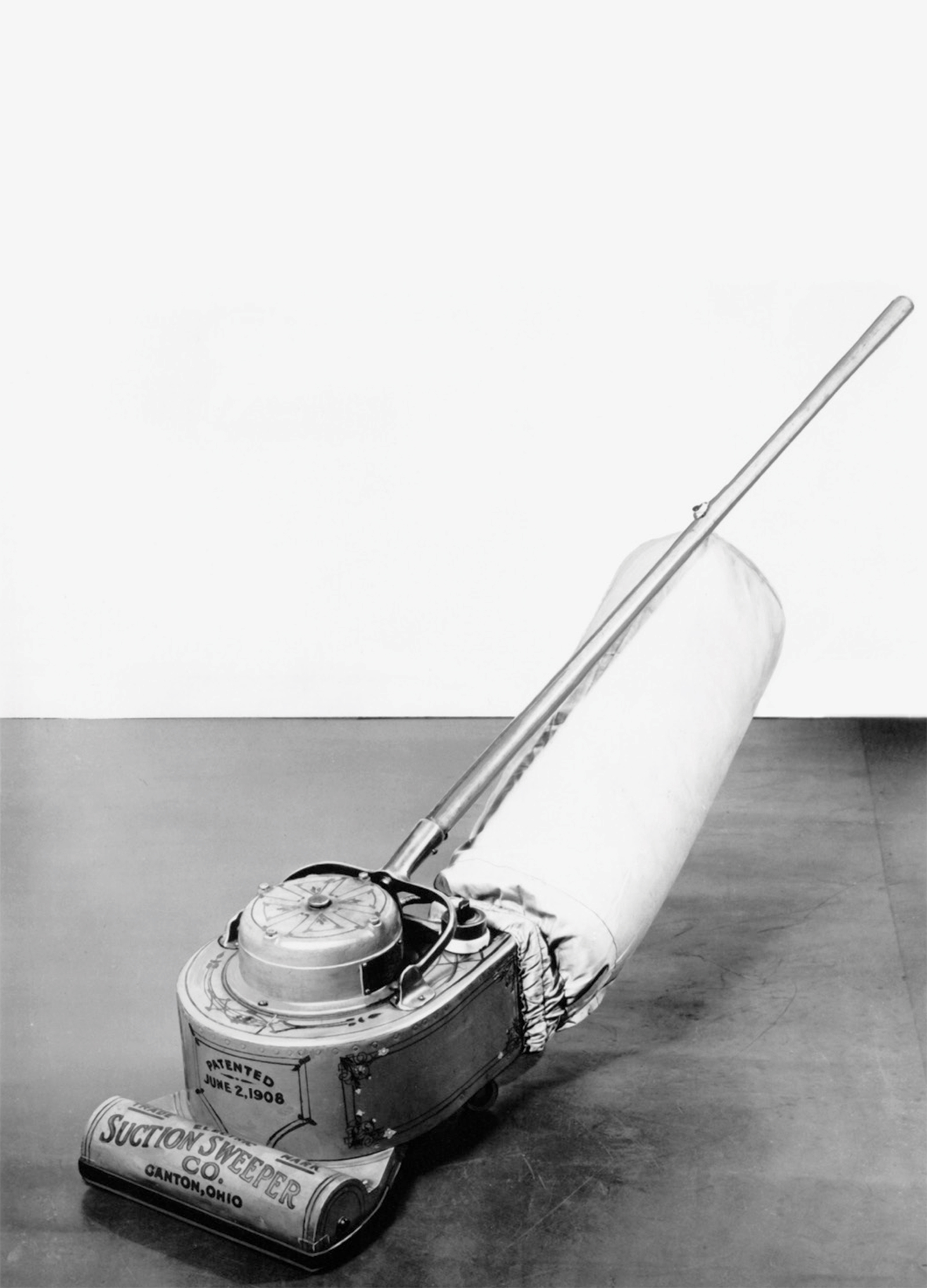 The front of this issue’s postcard featuring a photograph of the first production electric vacuum cleaner.