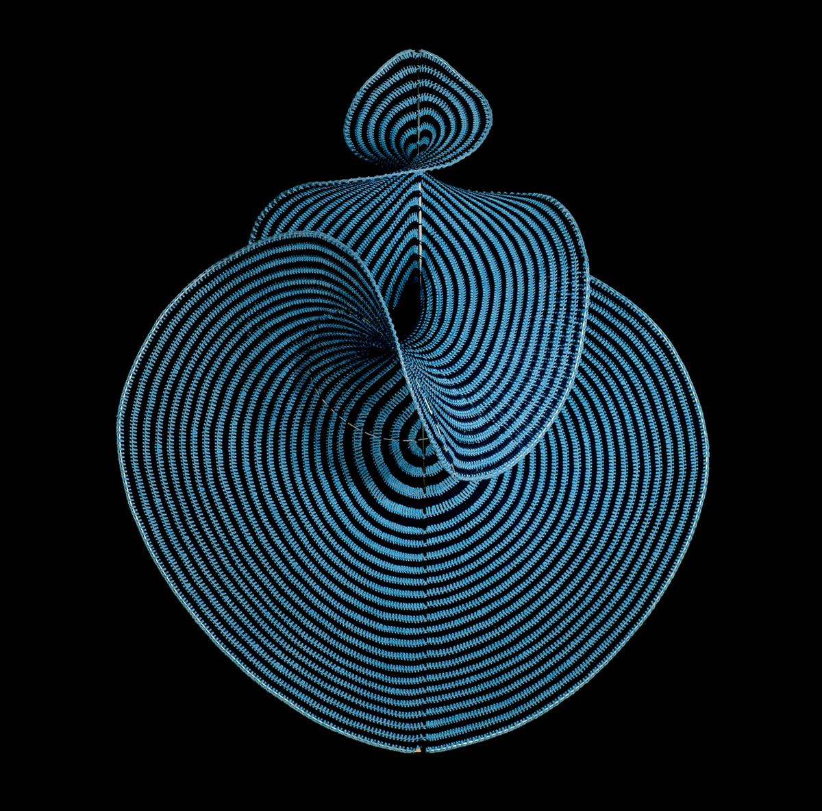 An image of the crocheted Lorenz manifold with a black background highlighting the surface aspect.