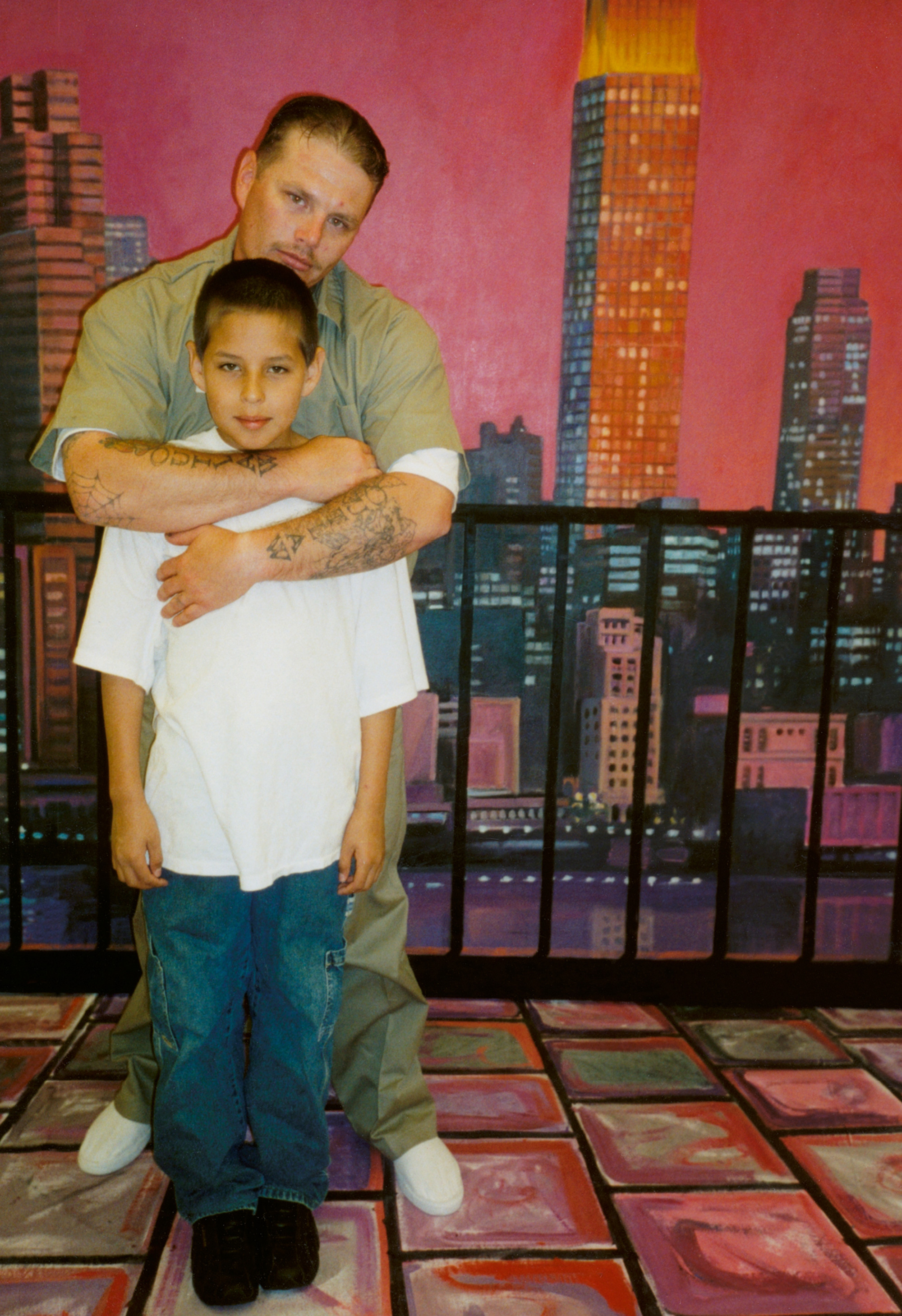 A photograph of Jason Jordon in front of a mural at the United States Penitentiary in Marion, Illinois.