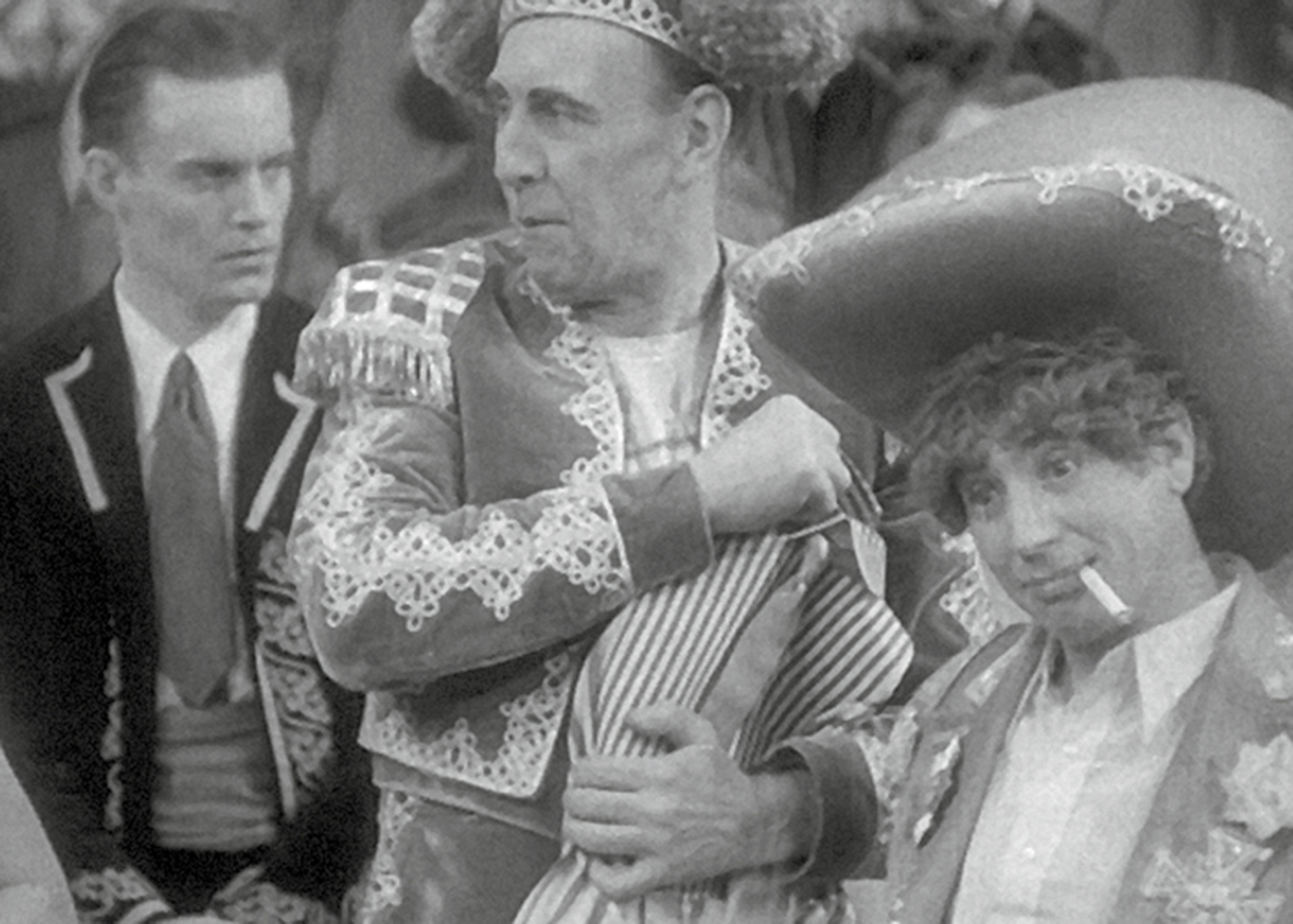 A still from the nineteen twenty nine film “The Cocoanuts” depicting Harpo Marx and his cigarillo.