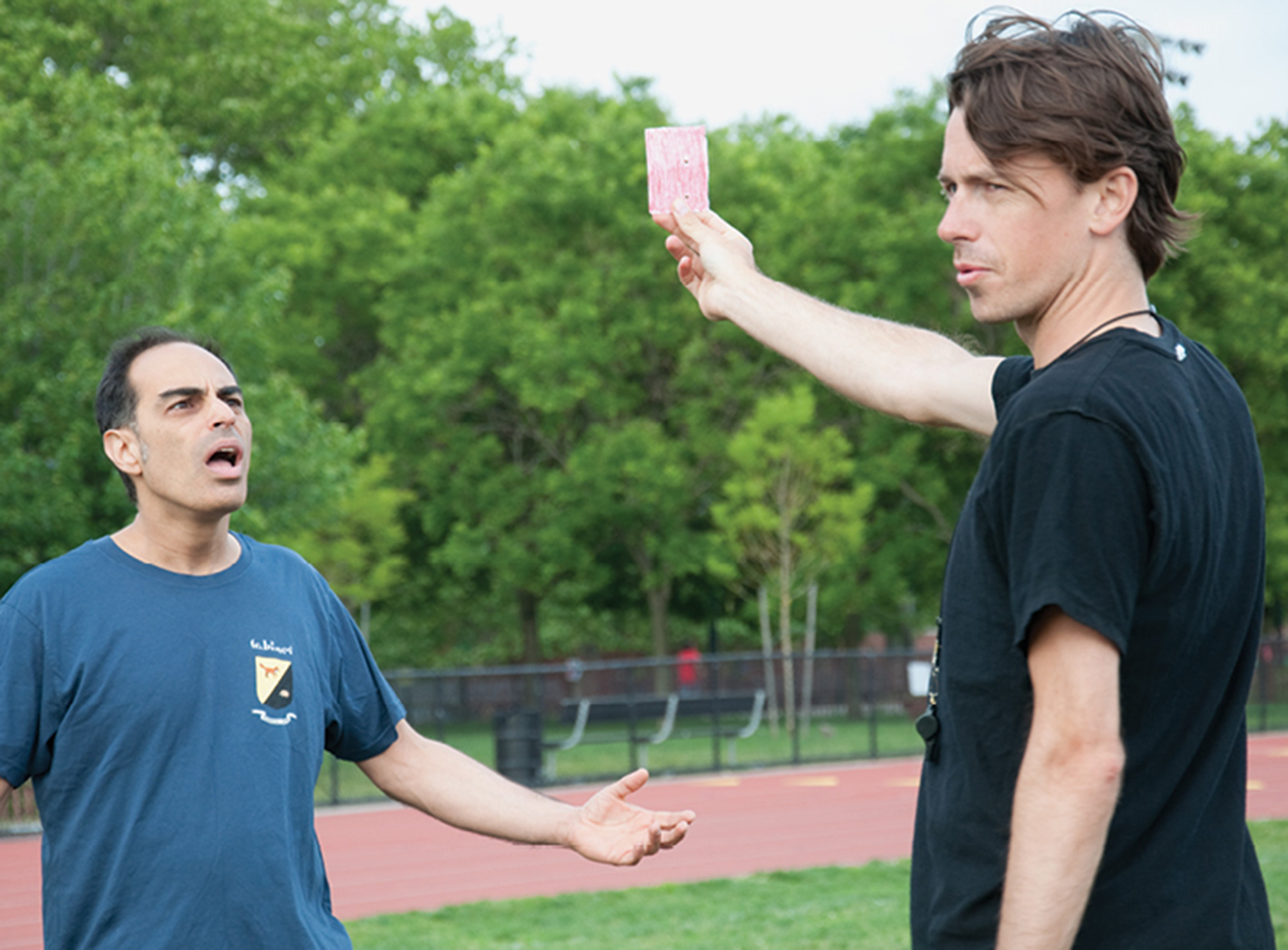 A photograph of Sina Najafi getting red-carded by the referee while waiting. Najafi had criticized the referee’s recent book on the philosopher Giorgio  Agamben.