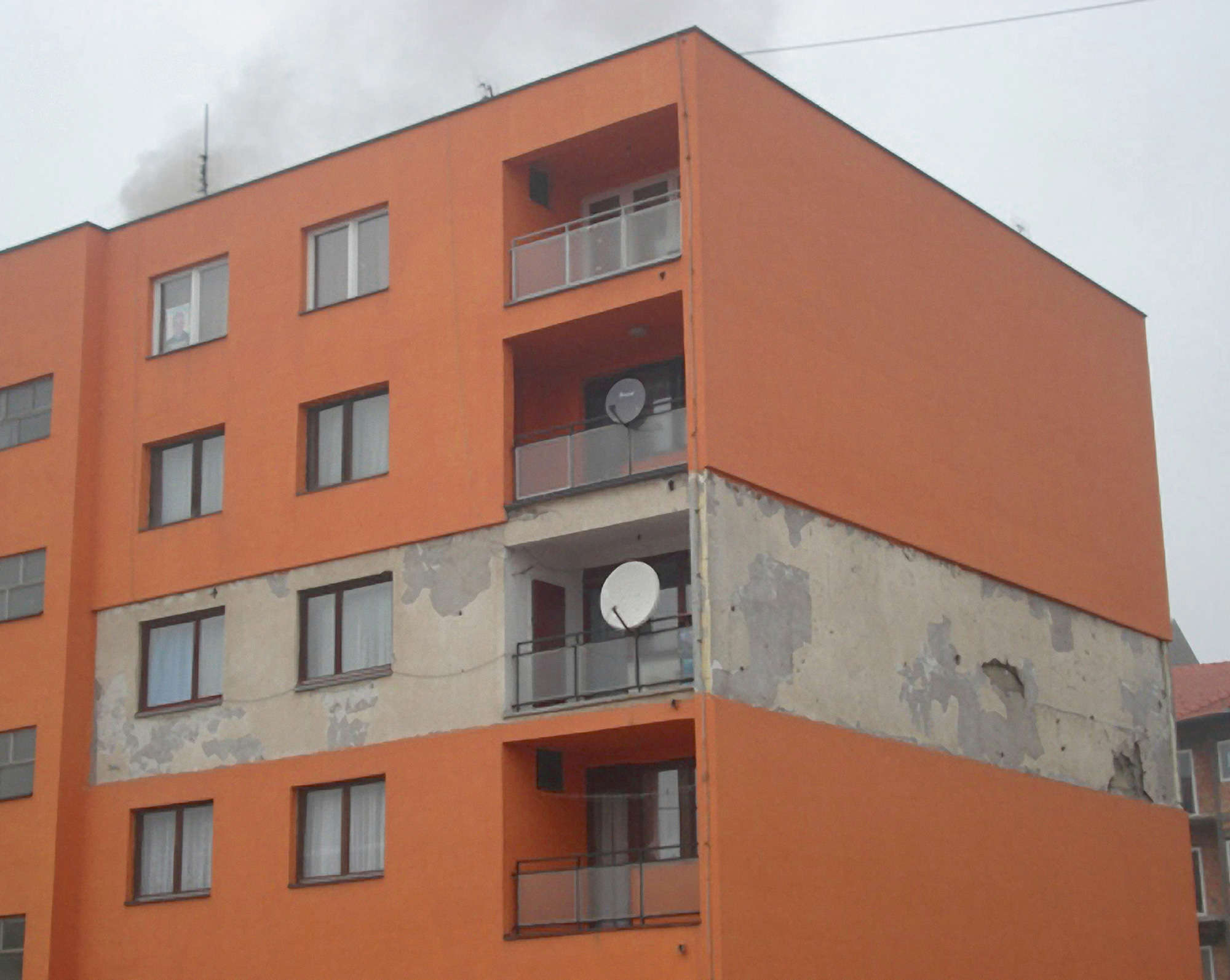 A two thousand and nine photo of the apartment building in Kalesija in the Federation of Bosnia and Herzegovina, where one residrnt has refused to have the facade of their portion of the building renovated. 