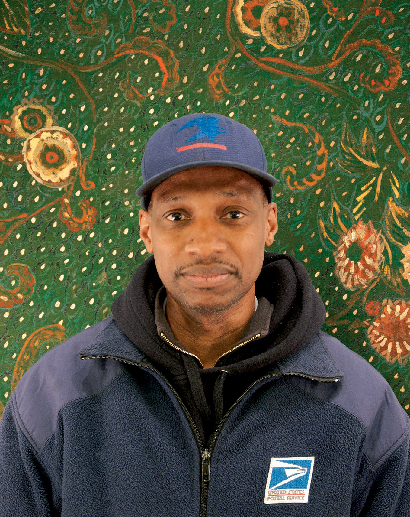 Postcard of the United States postal worker Raymond Bullard in front of a background made famous by Van Gogh’s iconic portrait of the postman Joseph Roulin.