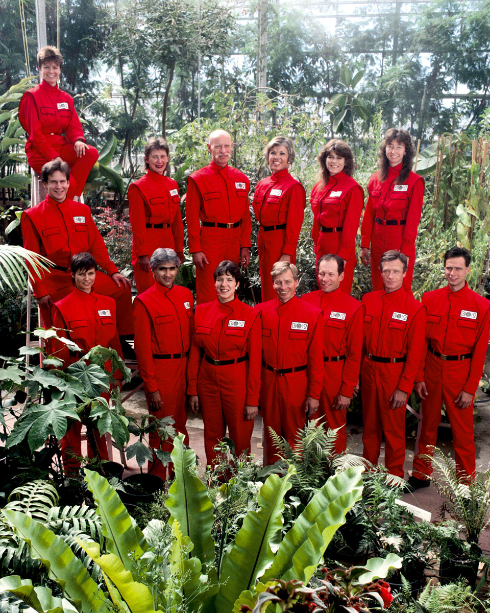 A group photograph of candidates for nineteen eighty-nine’s Biosphere two. Only six of the fourteen individuals shown were ultimately chosen to live in the biosphere, along with two others not present. A trim Roy Walford is in the back row sporting a moustache.