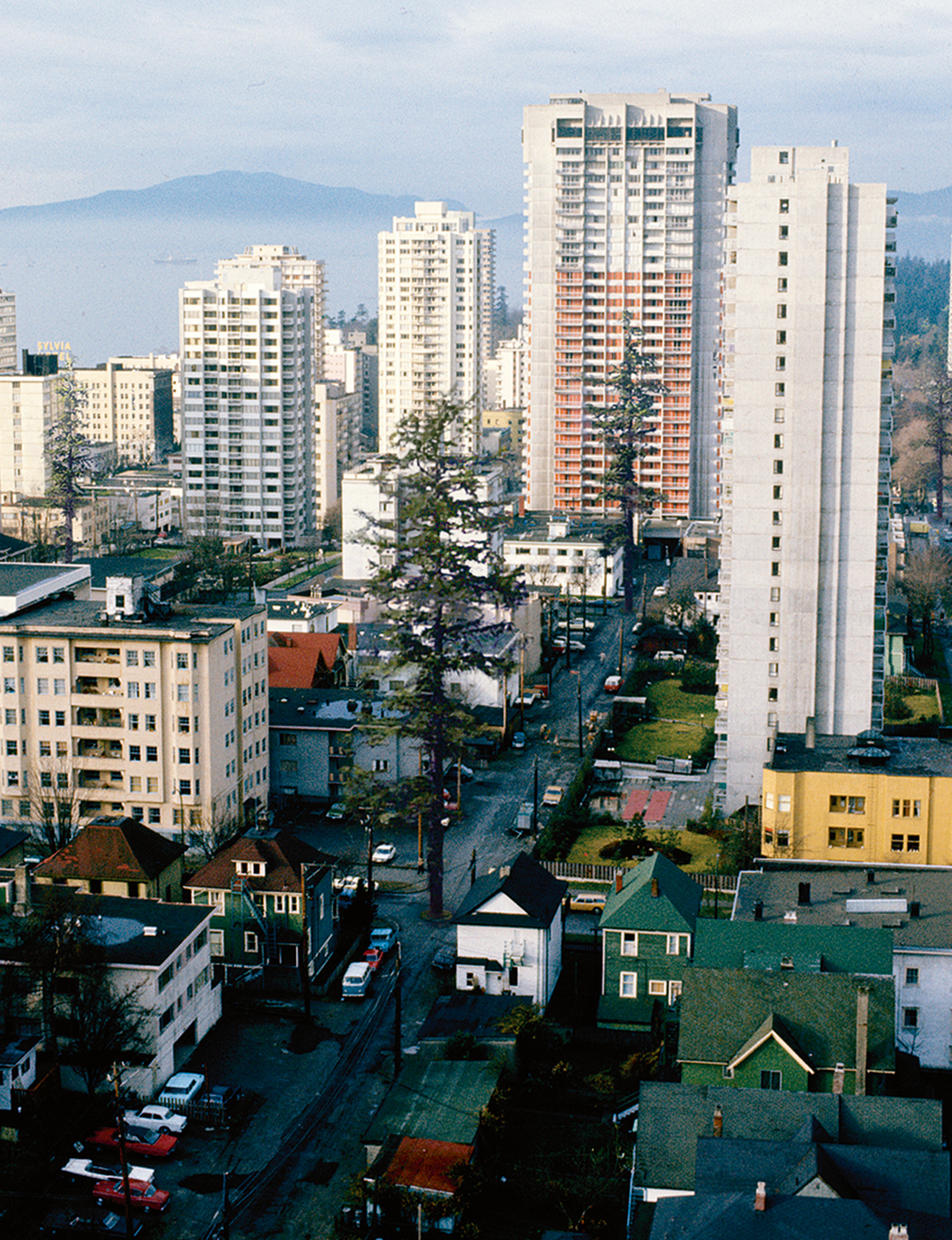 A photograph titled “Roundabout Vancouver: West End circa nineteen seventies.” It shows residential high rises.