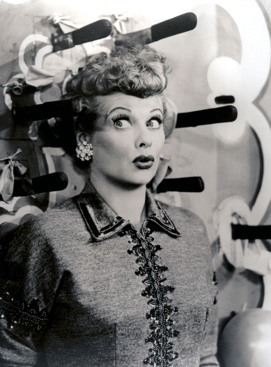 An image from “Lucy Tells The Truth,” the November ninth nineteen fifty-three episode of “I Love Lucy.” It depicts Lucy looking zany surrounded by throwing knives.