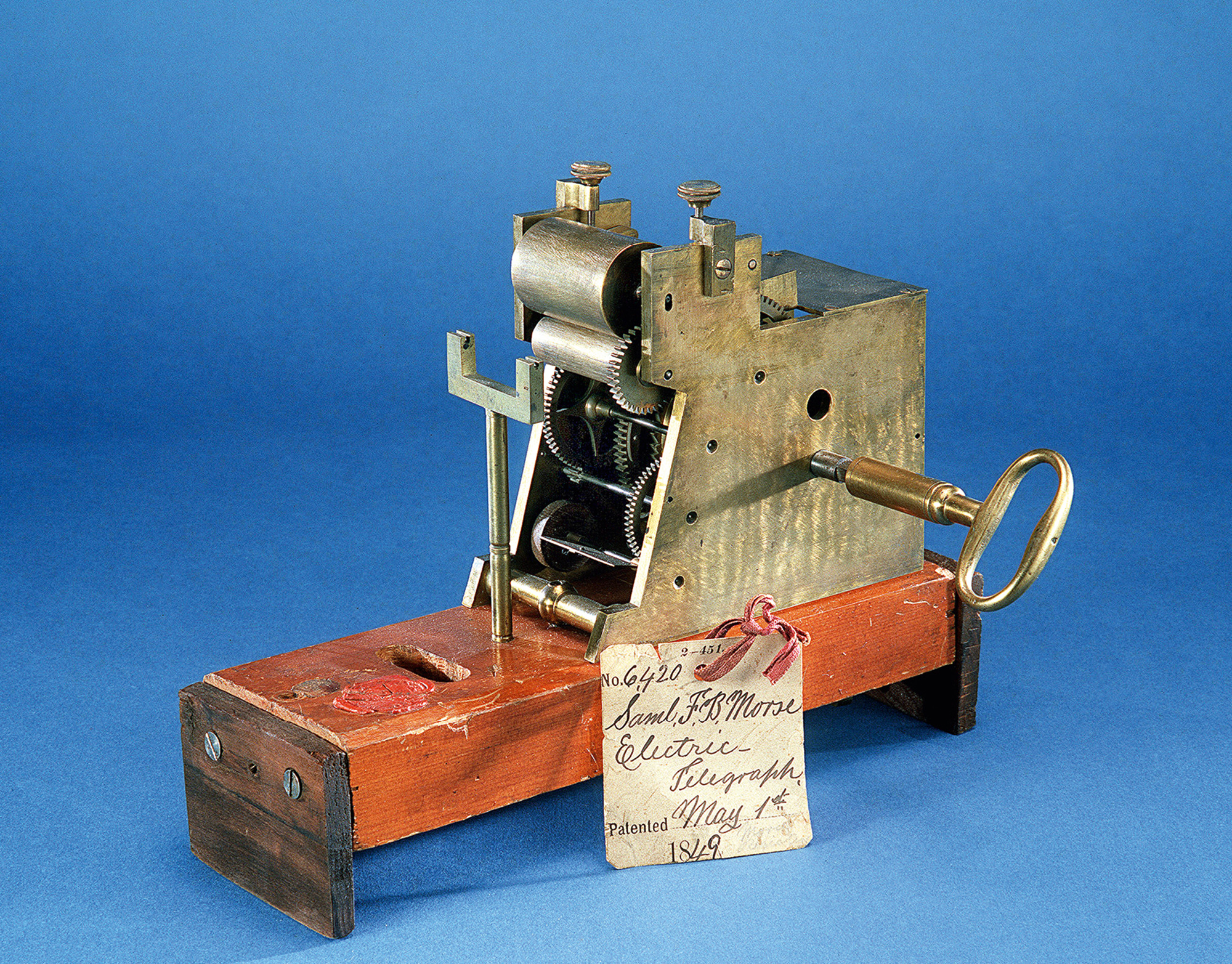 Samuel F. B. Morse conceived of an electromagnetic telegraph in 1832 and constructed an experimental version in 1835. His initial patent application in 1838 was approved in 1840. He received two further patents in 1846 and 1849, and this model of his 1844 receiver accompanied his application for the latter, in which he described a method for printing the dots and dashes of “Morse code” on paper. Courtesy Division of Work and Industry, National Museum of American History, Smithsonian Institution.