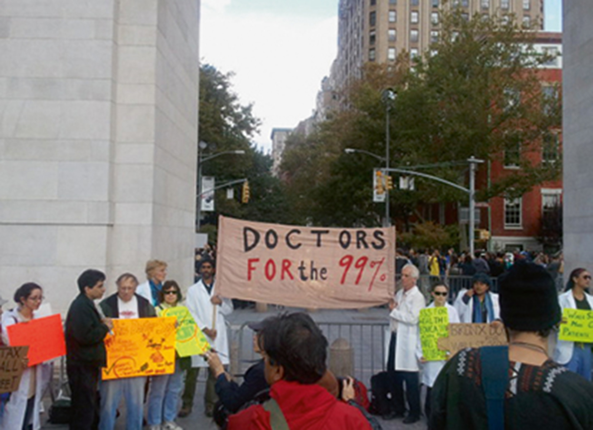 A twenty eleven photograph of a protest sign that reads “Doctors for the ninety-nine percent.”
