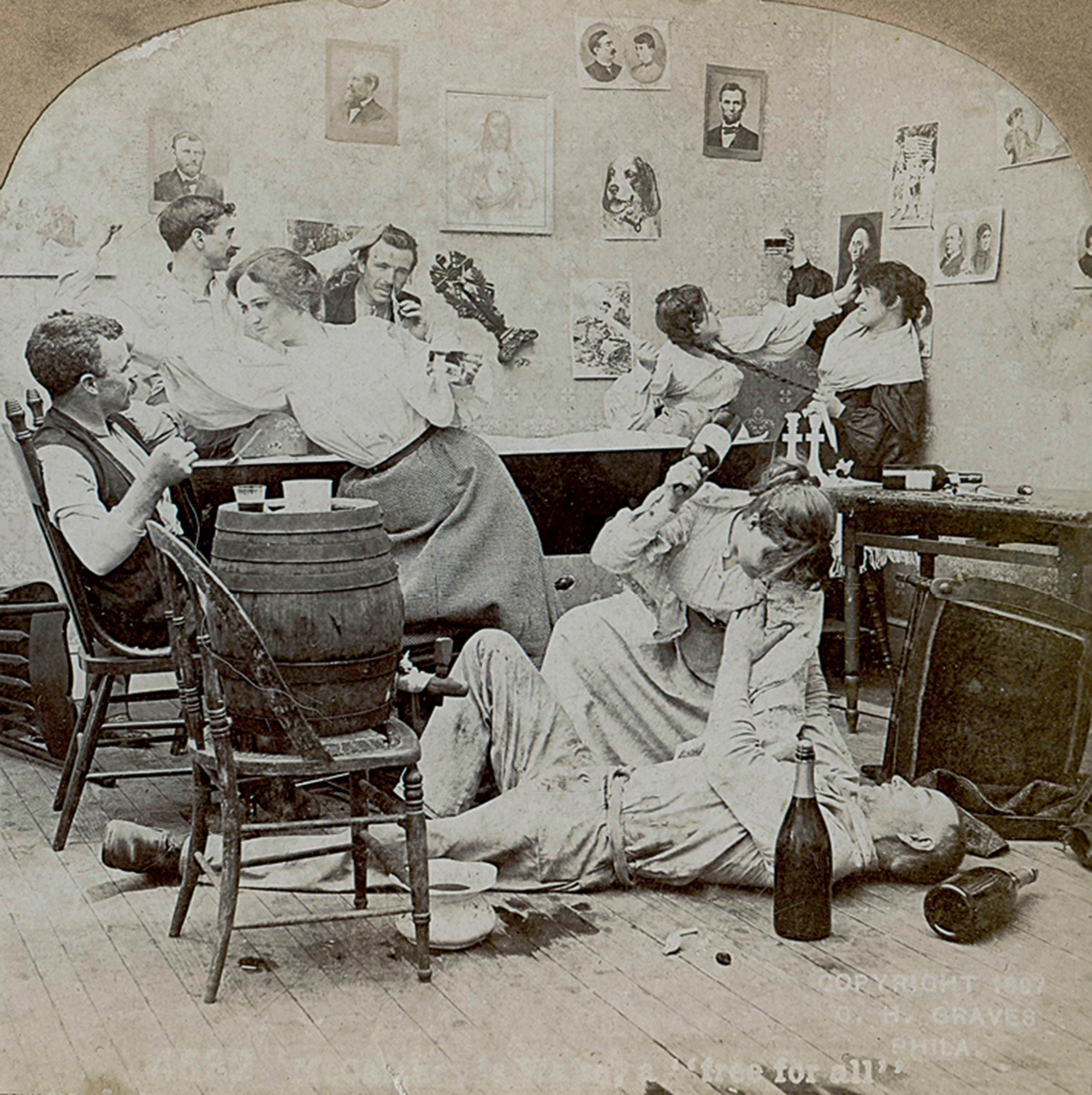 A reenactment of an Irish wake shown on a stereoview card published in Philadelphia in eighteen ninety-seven. Faint text on bottom reads: “McCarthy’s Wake, a ‘free for all.’”