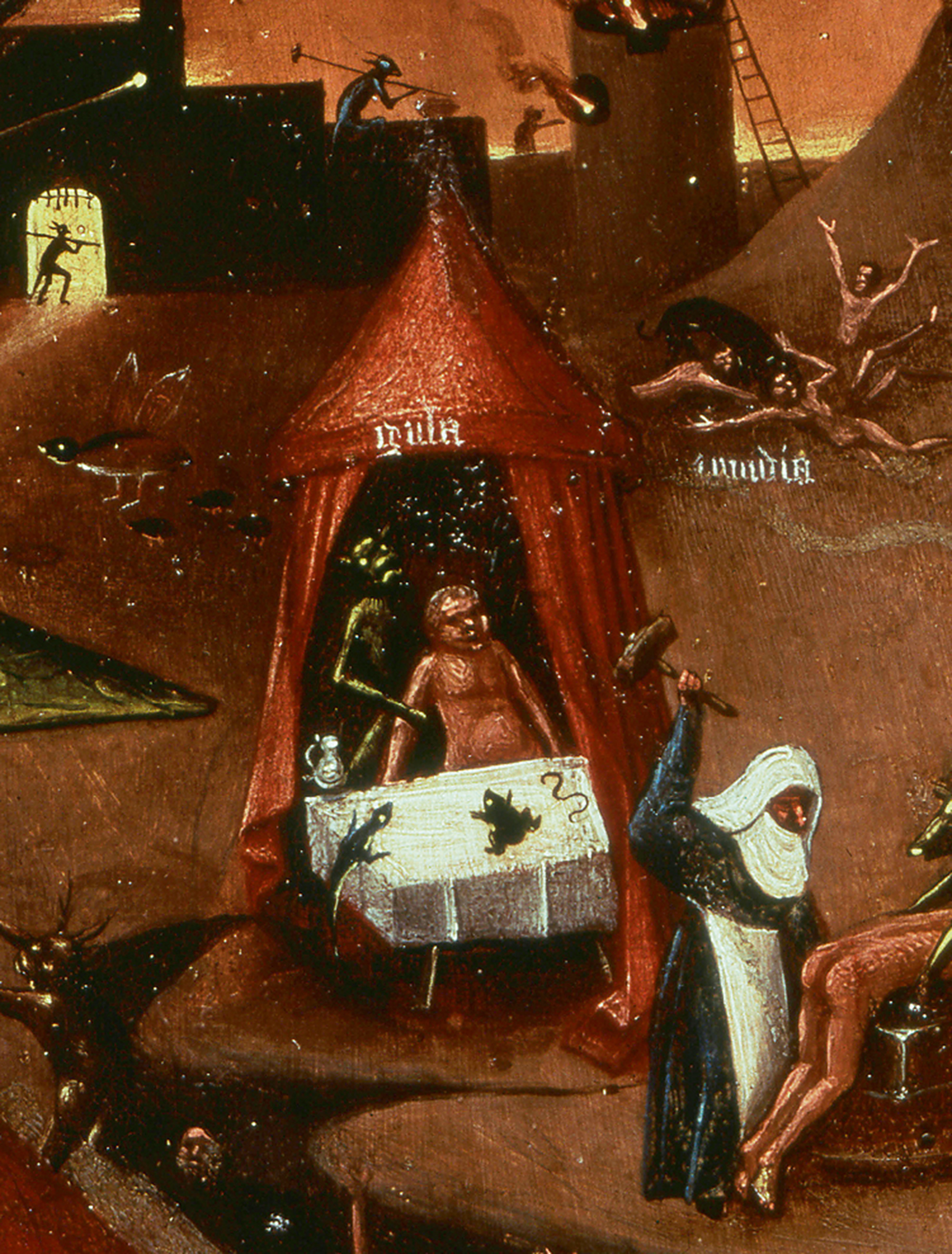 A detail from Hieronymus Bosch fourteen eighty painting titled “The Seven Deadly Sins.” It shows a scene in Hades where men are force-fed toads. 