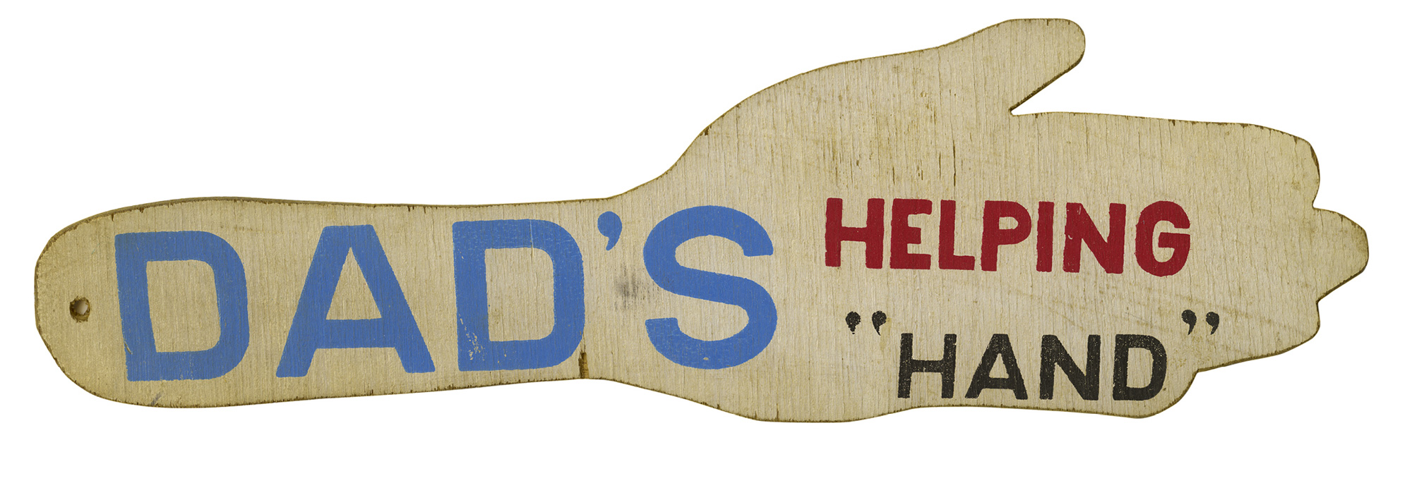 A wooden paddle shaped like a hand, made for corporal punishment, painted with the words “Dad’s helping hand.”