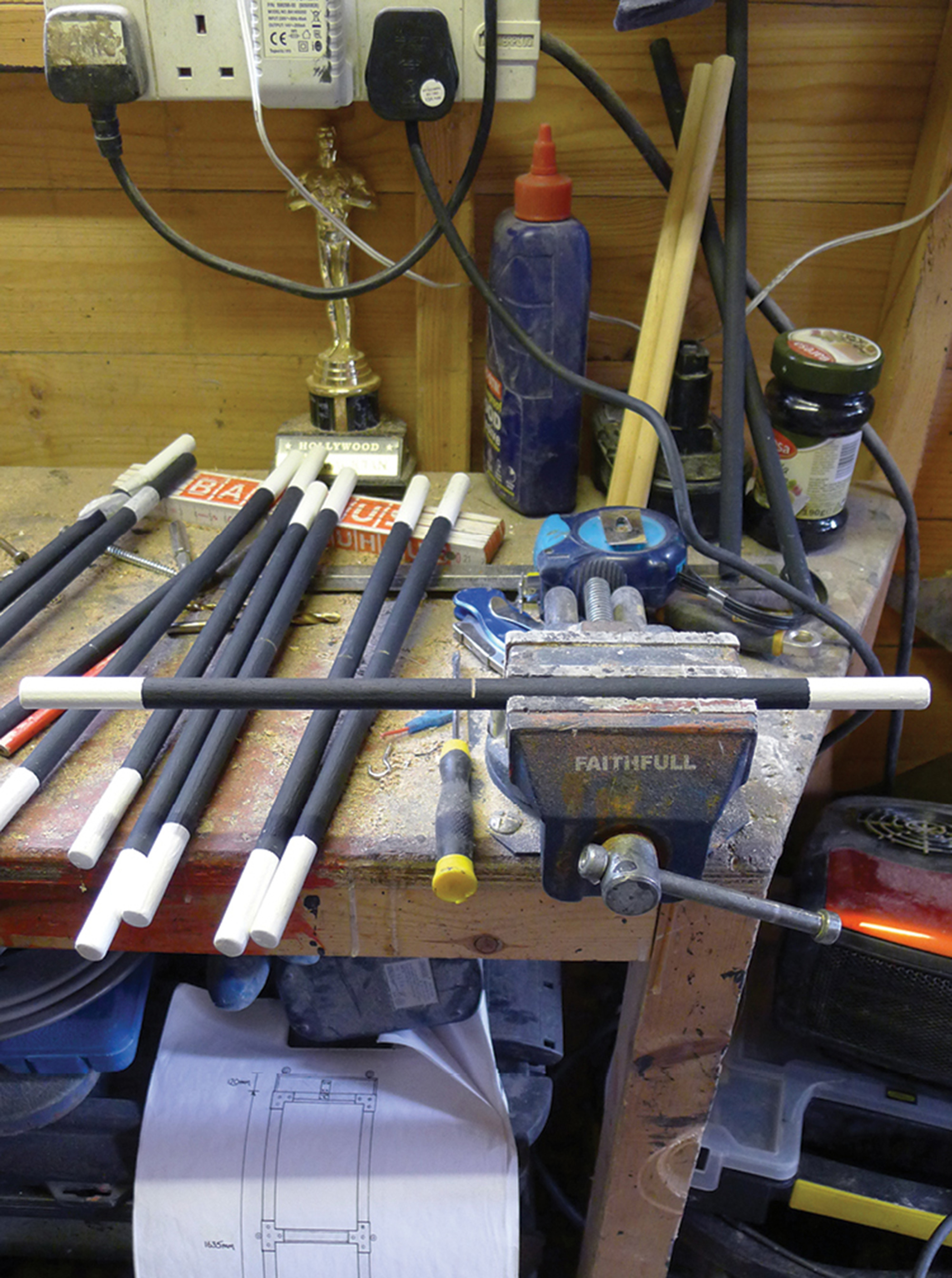A photograph of wands for funeral ceremonies being prepared in the workshop of magician Scott Penrose on behalf of the Magic Circle. Each wand is part-sawed in advance so that the break, when attempted, is not clumsy.