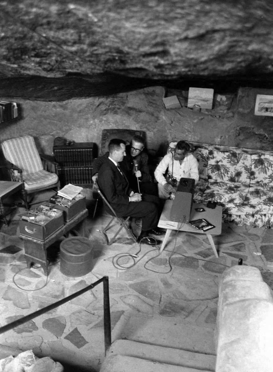 A photograph of three men in the cavern blasted out of the rock by Critzer, taken at the nineteen fifty-seven Interplanetary Spacecraft Convention at Giant Rock.