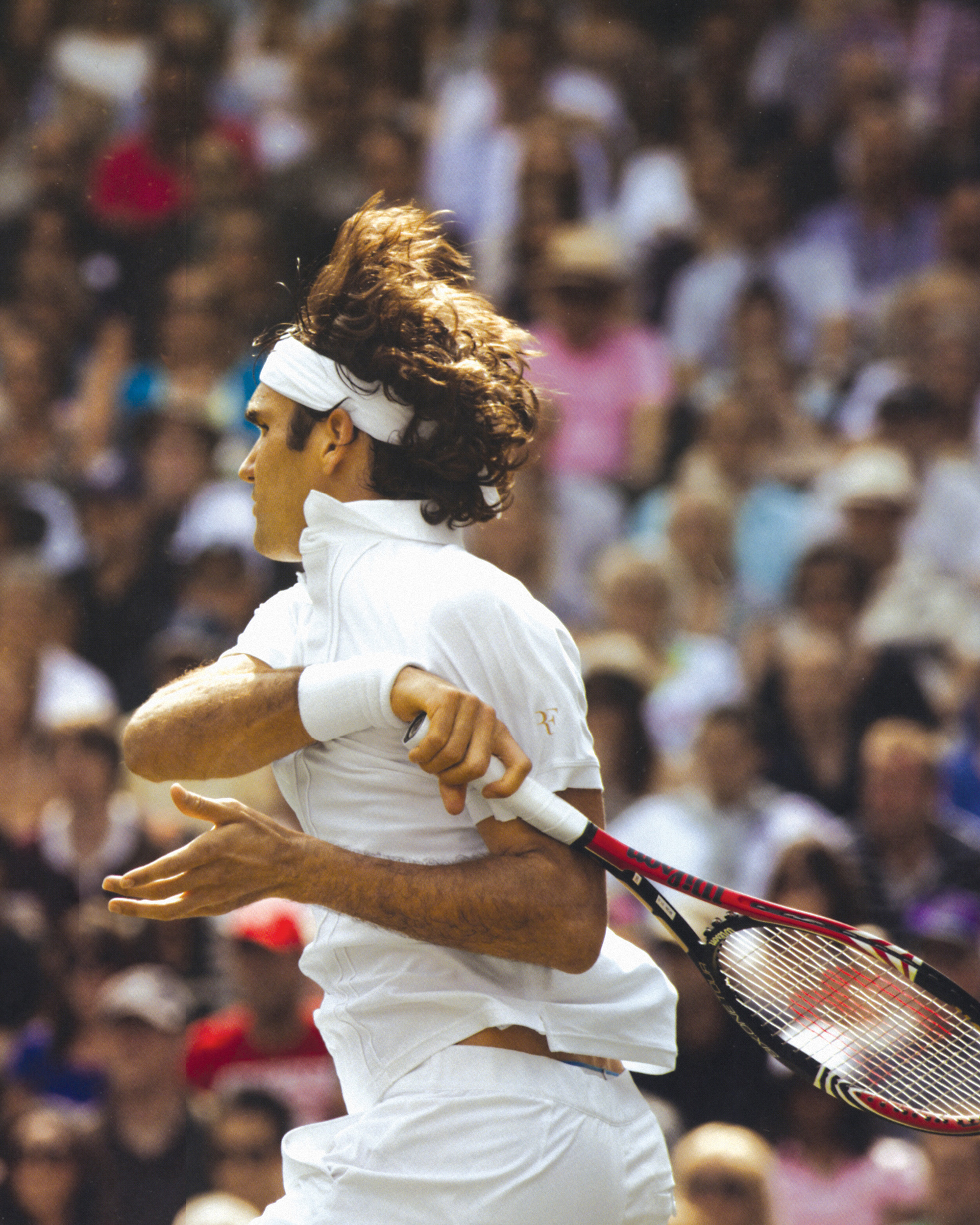 A photograph of Federer hitting a forehand at the two thousand and ten Wimbledon.