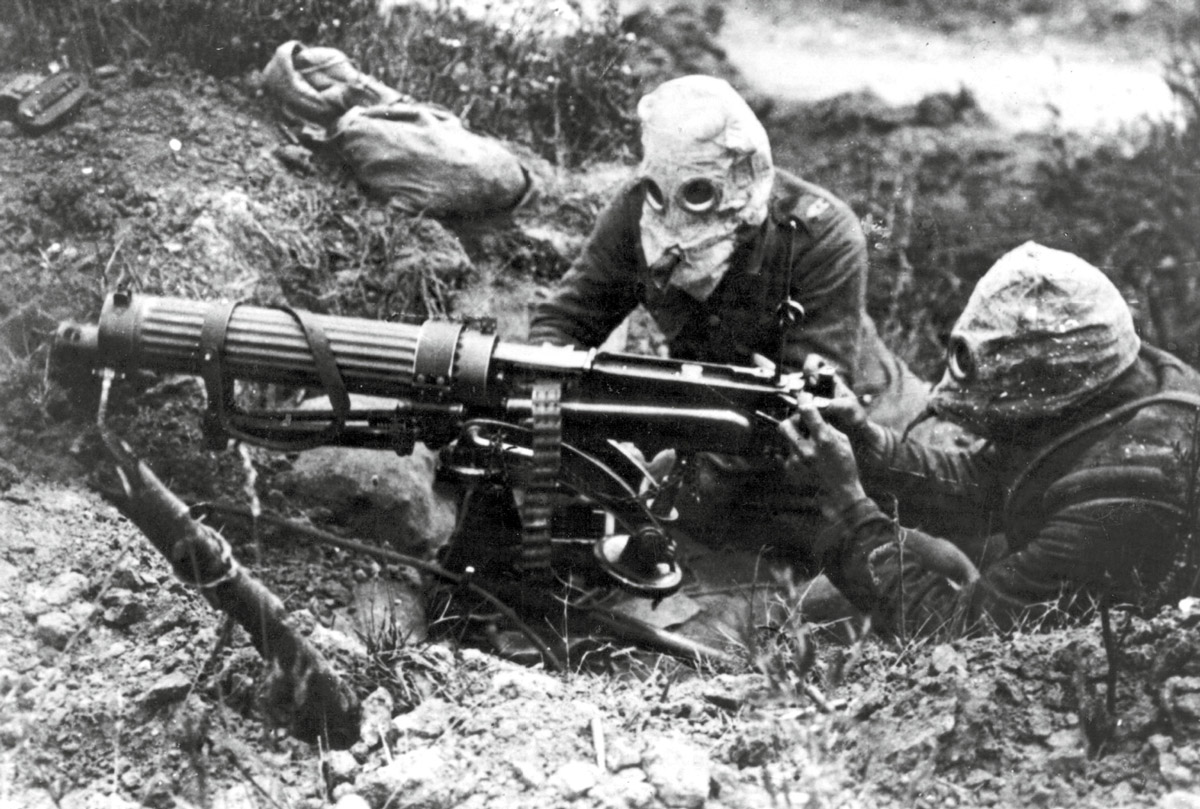 A photograph of two machine gun operators wearing gas masks in World War one.