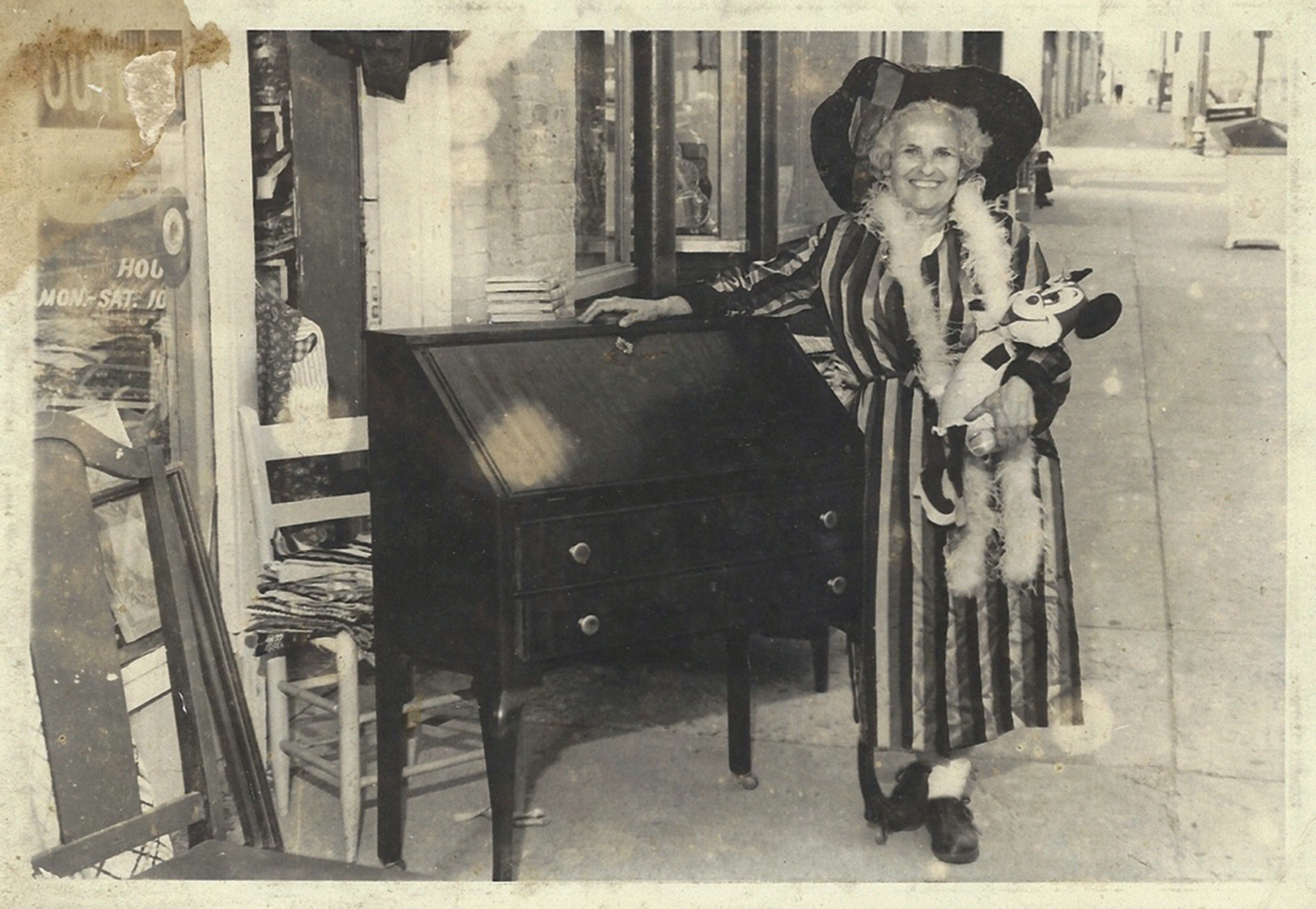 A circa nineteen seventy-eight photograph of Sylvia Gray in front of her surplus store.