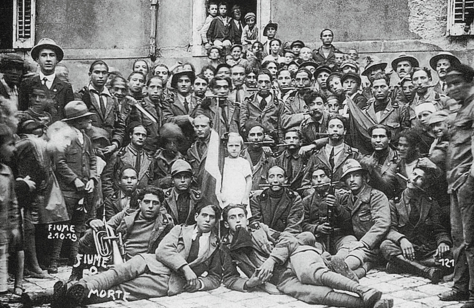 A group of arditi, Fiume, 2 October 1919. Holding daggers between their teeth, a practice these soldiers favored on the battlefield, became a symbol of their fighting spirit.
