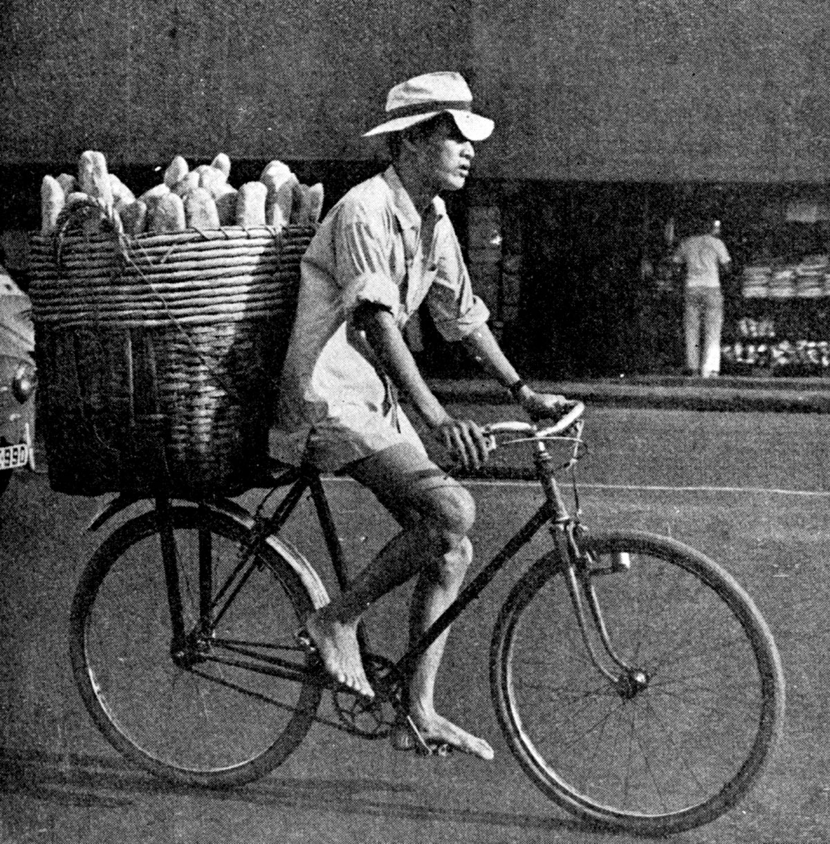 A photo of a man delivering bread on a bicycle. From a 1959 book published by the American Women’s Association of Saigon entitled “Saigon: A Booklet of Helpful Information for American in Vietnam.”