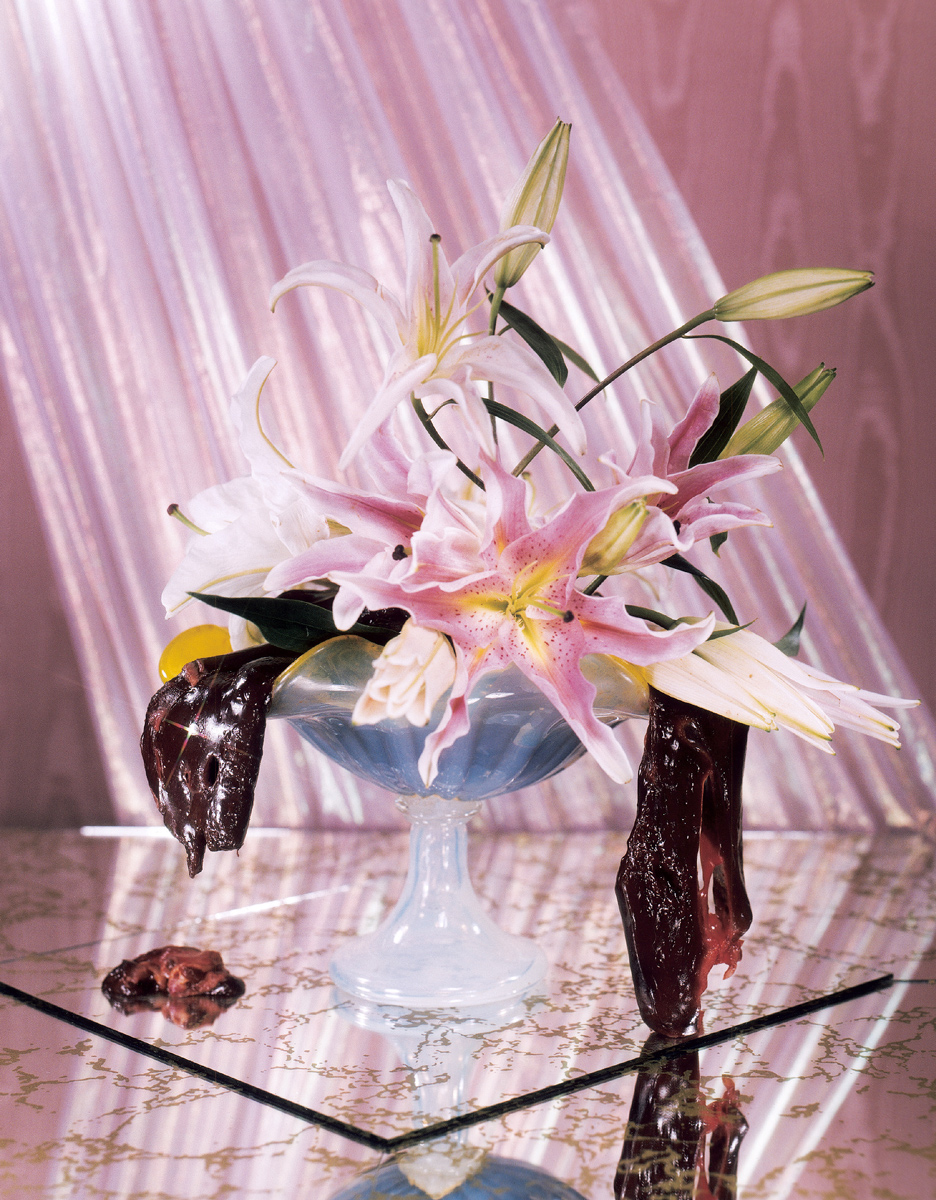 A 2002 artwork by Aaron Plant, Nick Debs, and Aaron Cobbett featuring a flower arrangement made with oriental lilies and beef liver entitled “The New Health Center.”