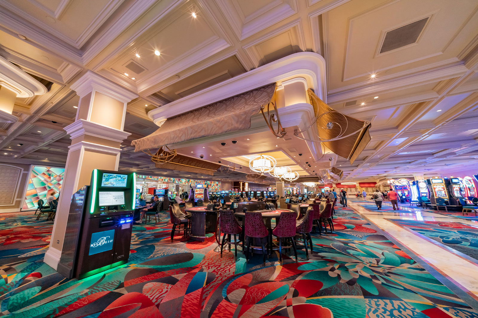 A photograph of gaming tables and slot machines in the casino at the Bellagio hotel, Las Vegas.