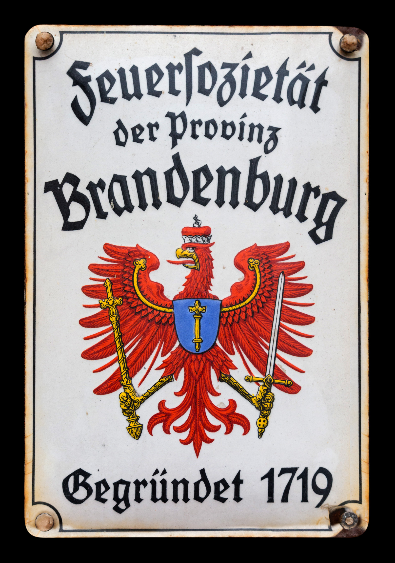 A photograph of a postwar fire mark issued by the Brandenburg Fire Society which includes the old imperial eagle.
