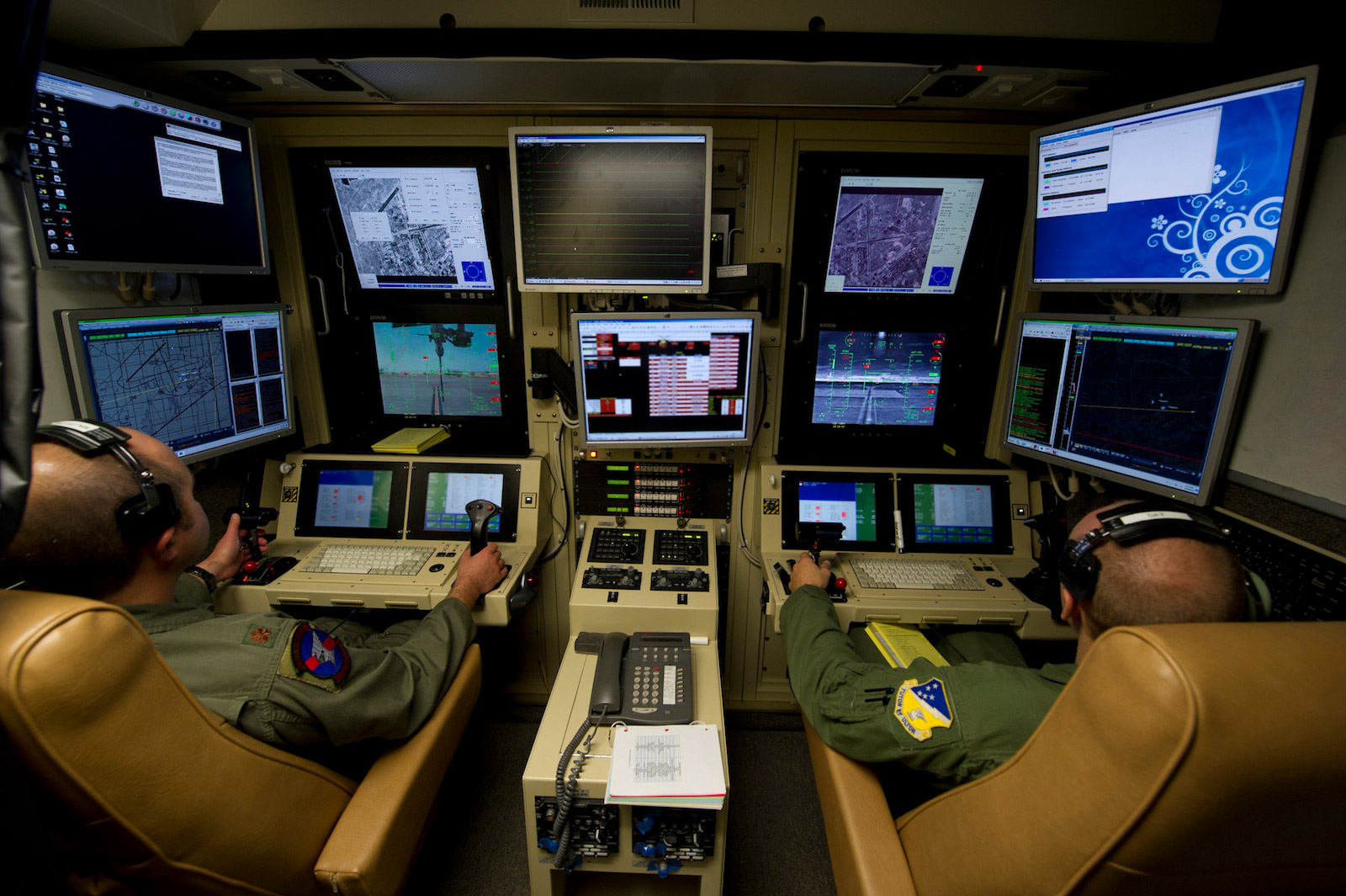 A twothousand and twelve photograph showing two United States airmen at New Mexico’s Holloman Air Force Base training to operate the MQ-9 Reaper drone.