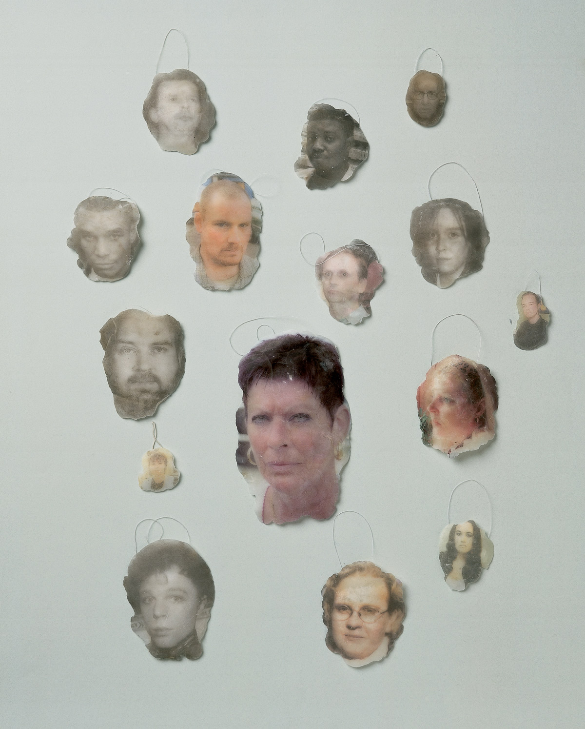 Wax medalions featuring images of disappointed and offended people made by artist Magnus Bärtås.