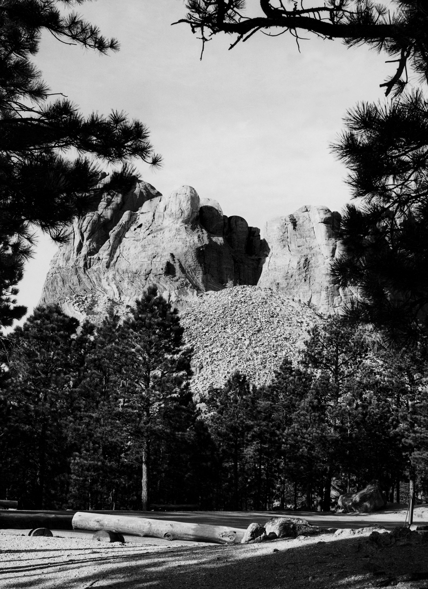 A photographic artwork by artist Matthew Buckingham’s depicting what the Six Grandfathers, known also as Mount Rushmore, might look like in the distant future was included in the issue as a poster.