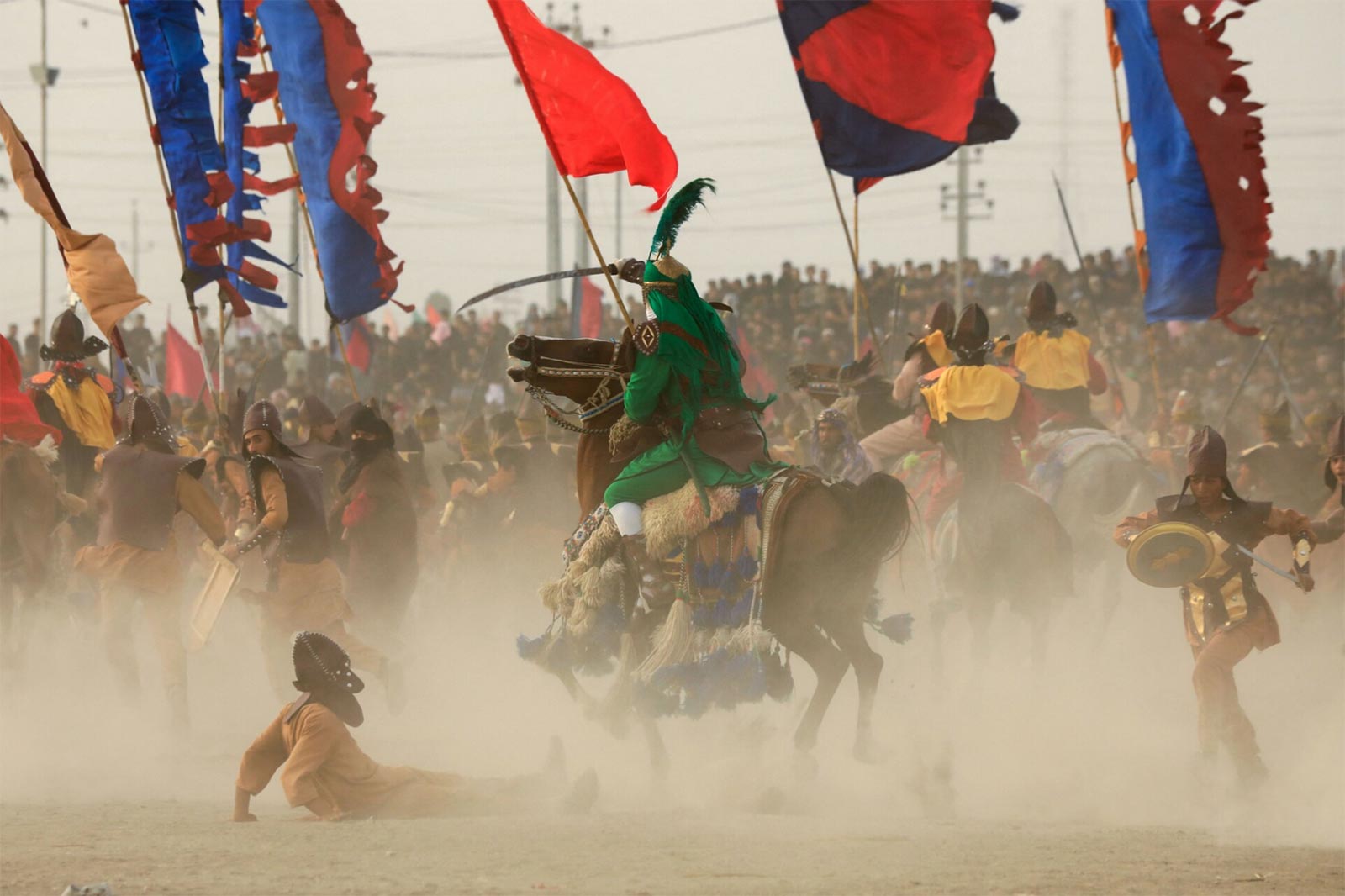 A twenty twenty-three photograph of a modern-day re-enactment of the Battle of Karbala during Ashura in Souk al-Shuyukh in Iraq’s Dhi Qar Governorate.