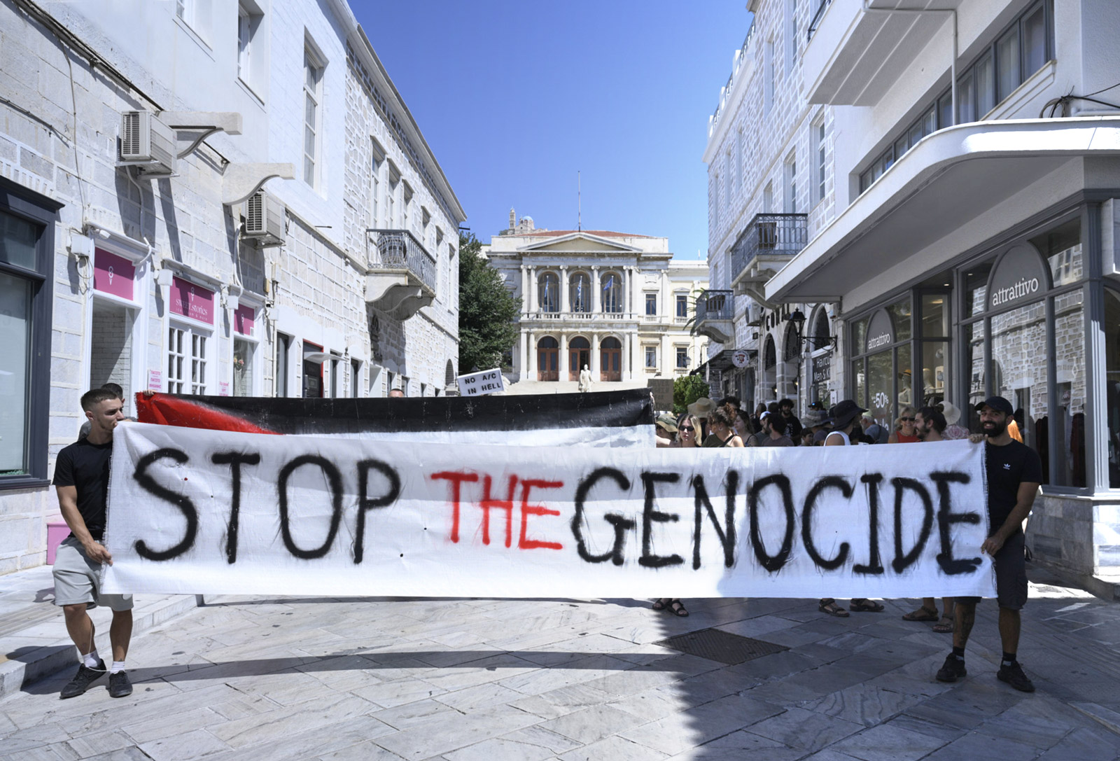 Protestors holding a banner that reads “Stop the Genocide” on Syros.
