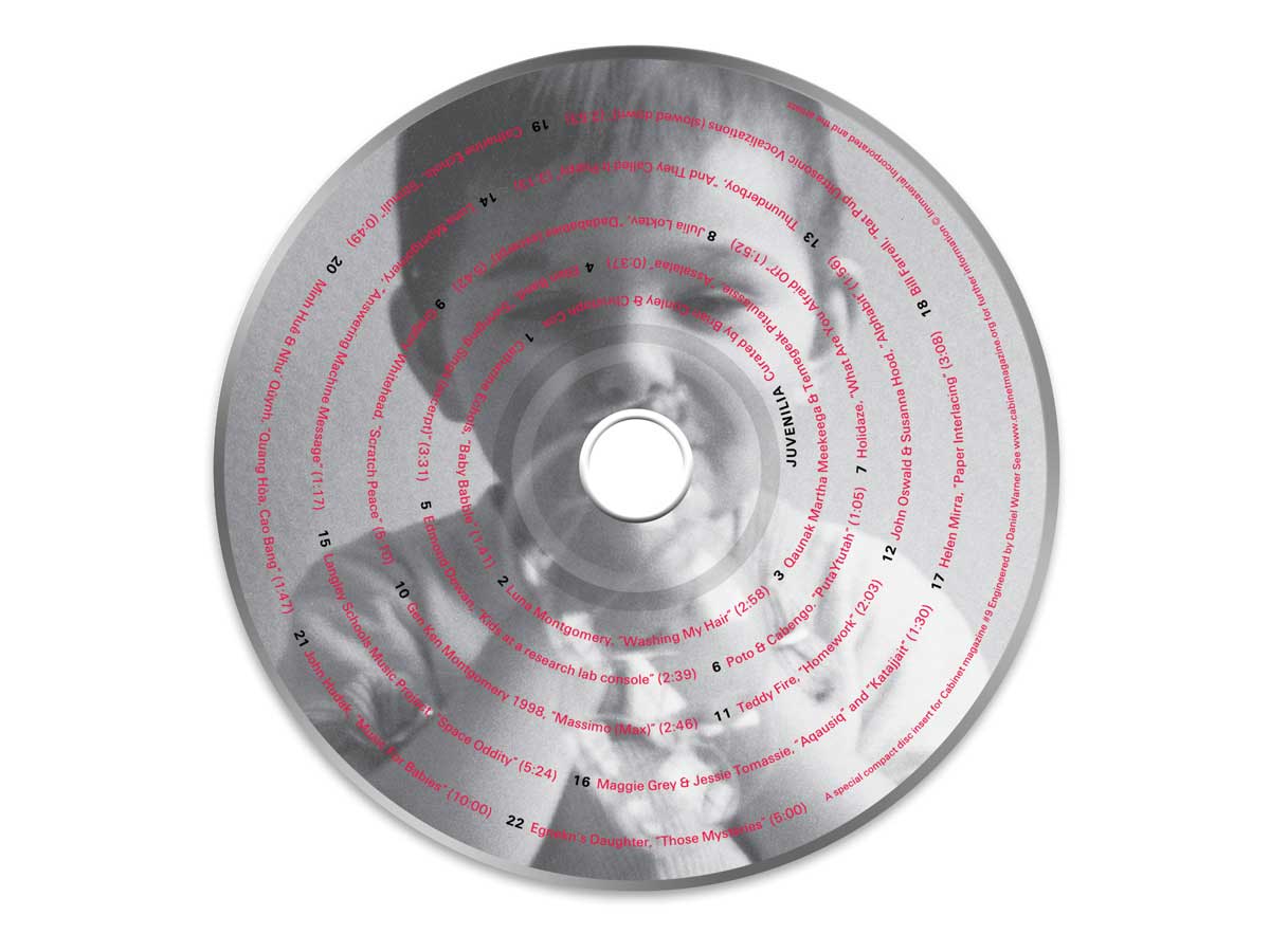 A photograph of the issue's Juvenilia CD. The tracks are listed on top of a found image of a child.
